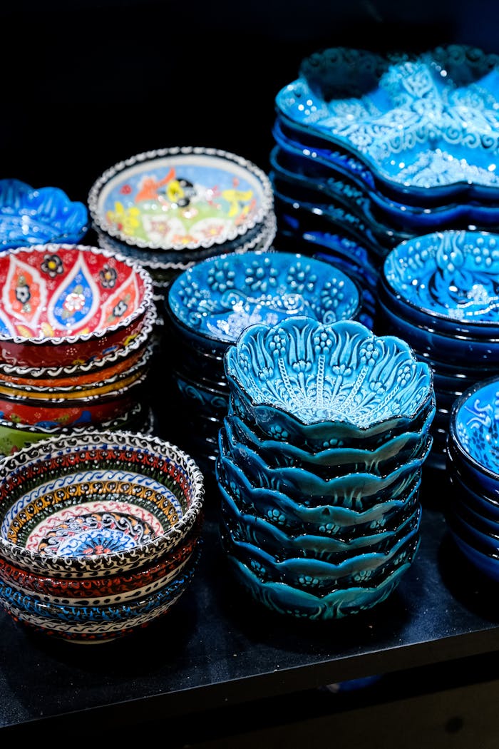 A collection of vibrant, stacked ceramic bowls showcasing intricate patterns and artistry. Perfect for tableware enthusiasts.