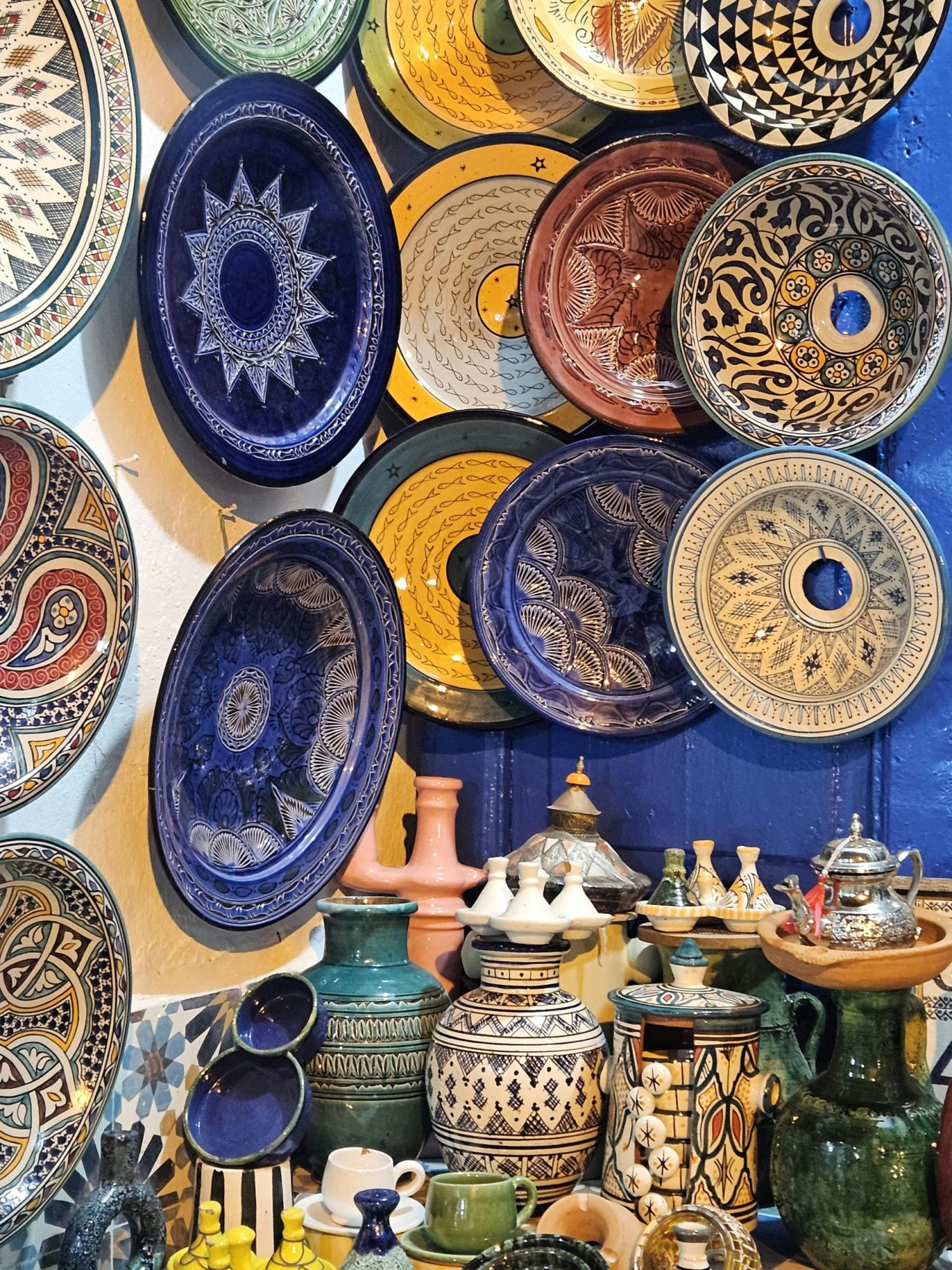 Vibrant display of traditional Moroccan pottery with intricate patterns and rich colors.